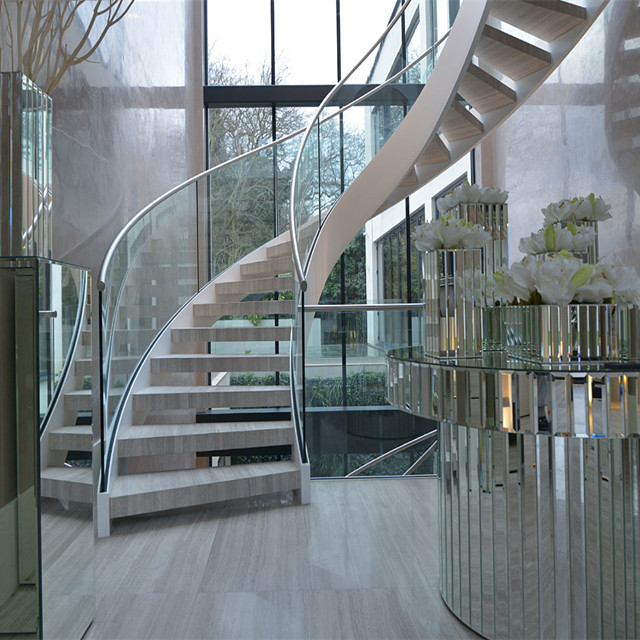 J-curved stairs marble stair tread and glass balustrade 